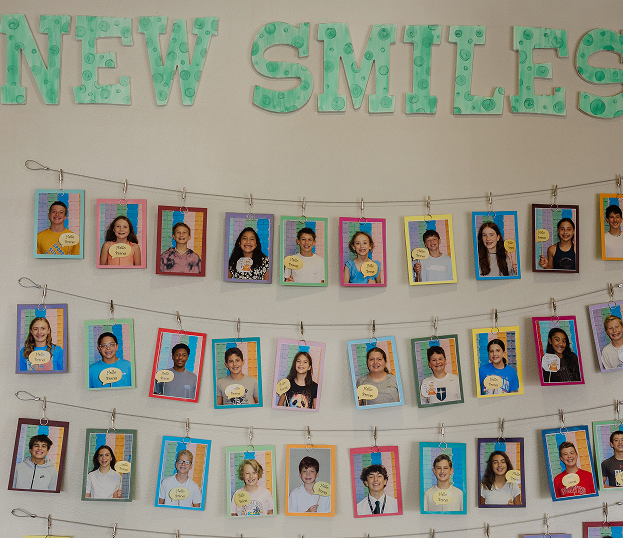 a wall with pictures of smiling patients